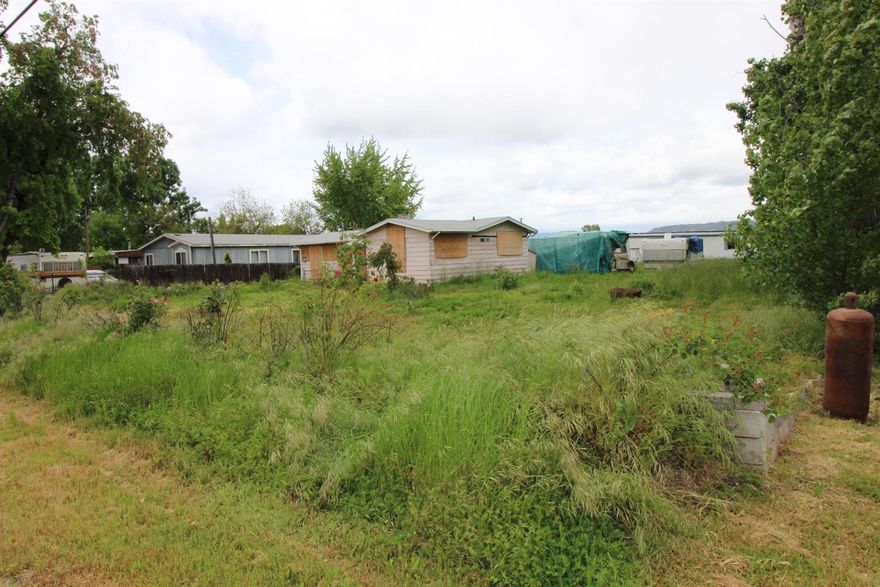 Want a fixer that is NOT a foreclosure!? Can you see the potential in this 1 acre property? If you have the means, desire and ability to 'fix things up' there are lots of so called opportunities with this purchase. This is an AS-IS sale (furnishings, tools, equipment, rv's included at no stated value)~including parked manufactured home (not on foundation) plus the stick built home, outbuildings and lots and lots of 'stuff'. The windows are boarded up for security (but seller says they are all in tact re., stick built home). Seller says well is strong.