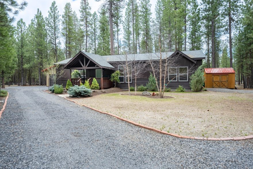 Discover this exceptional one-owner retreat that exudes character and showcases stunning landscaping!  Perfectly positioned on a corner lot within the sought-after Ponderosa Pines Subdivision—known for its fire-wise community—This Northwest Energy Star-Efficient 2018 built home boasts 3 bedrooms and 2 bathrooms 1620 sq feet and it has been meticulously cared for both inside and out. The open floor plan features a spacious kitchen, abundant storage, and nice finishes. With vinyl flooring, vaulted ceilings, large rooms, and bathrooms, and a thoughtfully designed split living layout, this home offers both comfort and functionality. Step outside to admire the beautifully landscaped yard, well-maintained fencing, and a substantial garage/shop equipped with work benches. Additionally, you'll find an approximate large hickory shed and another shed perfect for storage or gardening equipment. This property is truly a standout gem! Don't miss out on the opportunity to own this home!