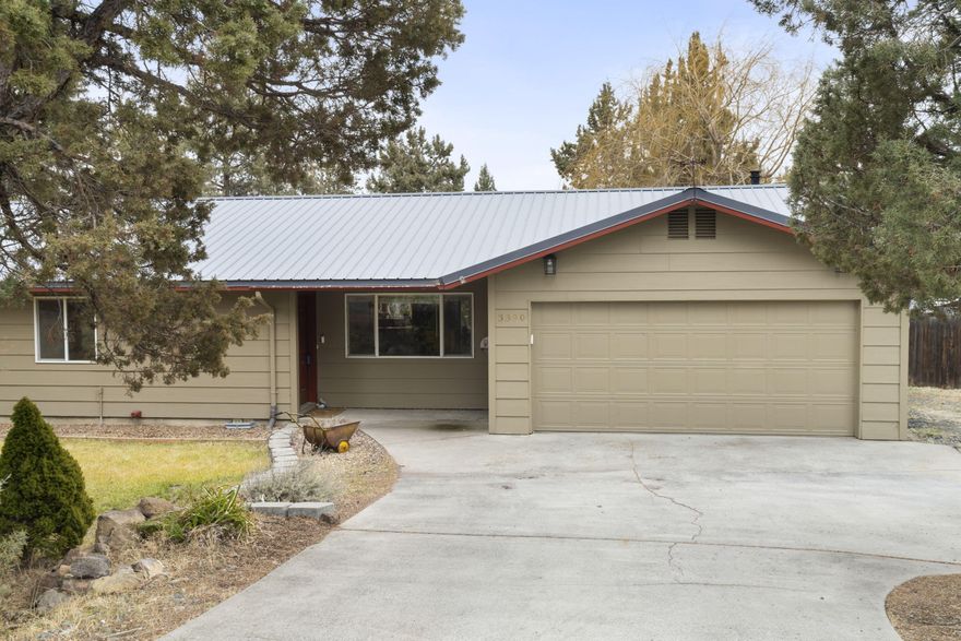 This tastefully updated home offers privacy and convenience on a spacious half-acre lot, just minutes from town with quick Hwy 97 access. The spacious, fully fenced backyard is amazing, featuring a covered deck, dog run, hot tub, and lush landscaping with mature fruit trees, hops and flowers. A charming, insulated garden shed/workshop with heat and electricity provides the perfect space for hobbies or storage. RV parking includes power and sewer hookup for added convenience. The remodeled kitchen features knotty maple soft-close cabinetry, granite counters, and a stylish backsplash. The great room features a cozy wood-burning fireplace, maple hardwood floors, and abundant natural light. Updated bathrooms add modern comfort, while a durable metal roof, installed in 2017, ensures peace of mind. Multiple outdoor spaces make this home ideal for entertaining or relaxing. Don't miss this rare opportunity to own a beautiful slice of Redmond!