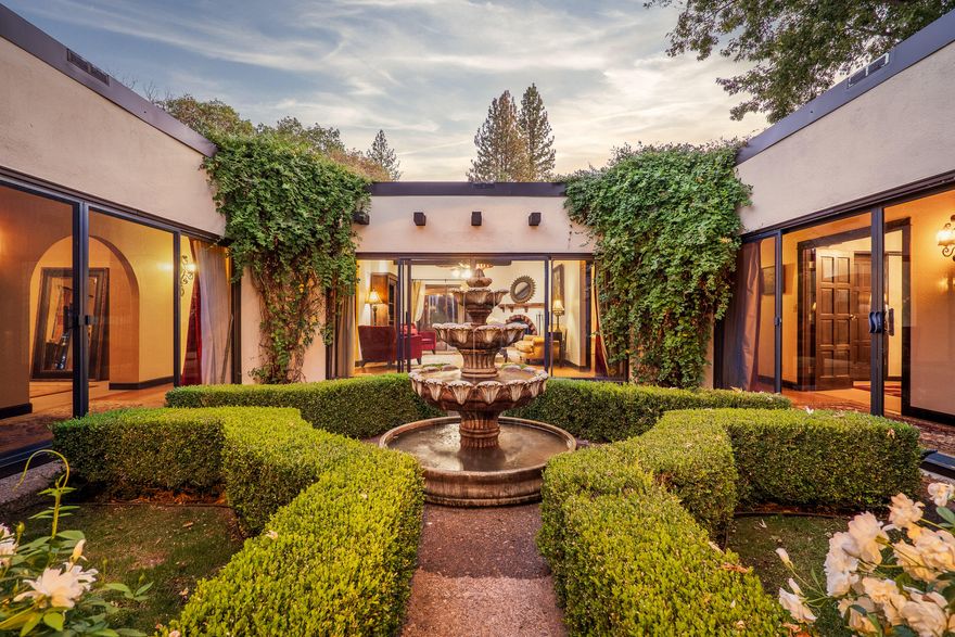 Welcome to Dark Hollow Estate. This secluded 8.55 acres features a mission style home with three bedrooms, two baths, multiple living spaces, & a beautiful in-ground pool.  A gated circle drive & beautiful curbed lawn area greets & leads guests to the home's quintessential courtyard.  The driveway then wraps around the house & leads to the detached garage as well as 4 additional outbuildings totaling over 6,000 sq. ft.   Fully fenced & cross fenced, the landscape, & setting provides privacy to a home nestled under the trees with a shaded & peaceful ambiance.  To the west the lot opens up to a large pasture for animals or garden with great sun exposure. This property presents country living at its best & is just a short distance from all the conveniences of Jacksonville, Medford, & Ashland. The front of the home offers an alluring appeal with a peaceful water feature sitting in the middle of the courtyard. The design provides a unique atmosphere not found in many Southern Oregon homes.