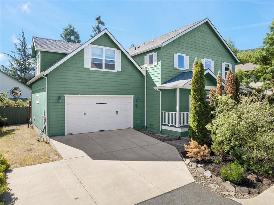 An unexpected treasure on a private flag lot near downtown Talent! This contemporary Craftsman home impresses with generous proportions and high ceilings. Downstairs, an open floor plan with hardwood floors, a gas fireplace and upscale fixtures and finishes creates a casual elegance. The kitchen, beautifully remodeled in 2023, features new stainless steel appliances, sleek cabinets, and solid-surface countertops. The living and dining areas open onto a large covered patio overlooking a private, fully fenced back yard. A full bath rounds out the downstairs. Upstairs, you'll find a large primary suite with two walk-in closets and a large en suite bath with granite-topped dual vanity. One of the three additional bedrooms is HUGE, with windows on three sides framing mountain views. Use it as a bedroom, second family room or play room. RV parking next to the oversized garage for your toys! Enjoy privacy and small town living with convenient access to I5, Ashland and Medford.