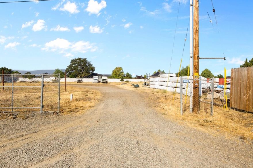 One-acre flat lot located just off Table Rock Road in Central Point's industrial corridor. Tucked behind an established commercial building, this property offers privacy with convenient access. The site includes a gravel drive and level terrain, making it ideal for storage, contractor use, or future development. Surrounded by thriving industrial businesses and close to major transportation routes, this parcel is a versatile investment opportunity.