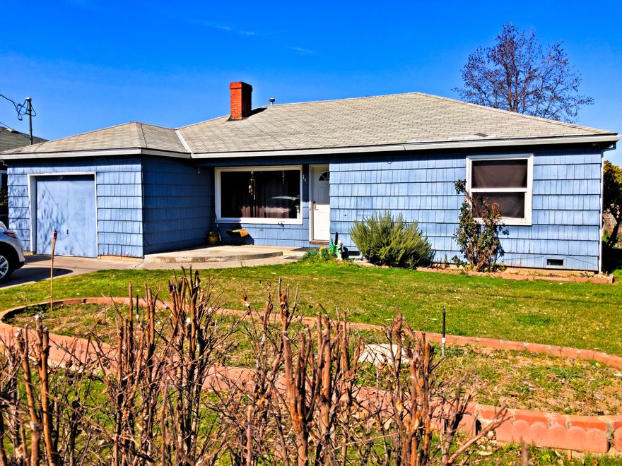 Diamond in the rough opportunity. This one level 3brm/1bth midcentury home needs a little cosmetic tune-up.  Great solid 1952 bones. Updates were many and made by previous owner with custom oak cabinets throughout, vinyl windows, canned lighting in the kitchen, Tile floors in kitchen and Bath. The bathroom has had an updated tub and vanity installed as well as lien cabinet. The kitchen is large and perfect for a couple of chefs to work with tons of storage, counterspace and an island with eating bar.  Out Back is a extra Large covered Patio and fenced yard. There is a 1 car Garage with a 2 car parking driveway in front and an additional 2 car driveway/parking off of the alley with Carport and attached storage. Would be great for RV or boat parking as well. This one is being Sold ''As Is'' at this price. Tenants have been a little rough on the home, but it won't take much to get this one shining bright.