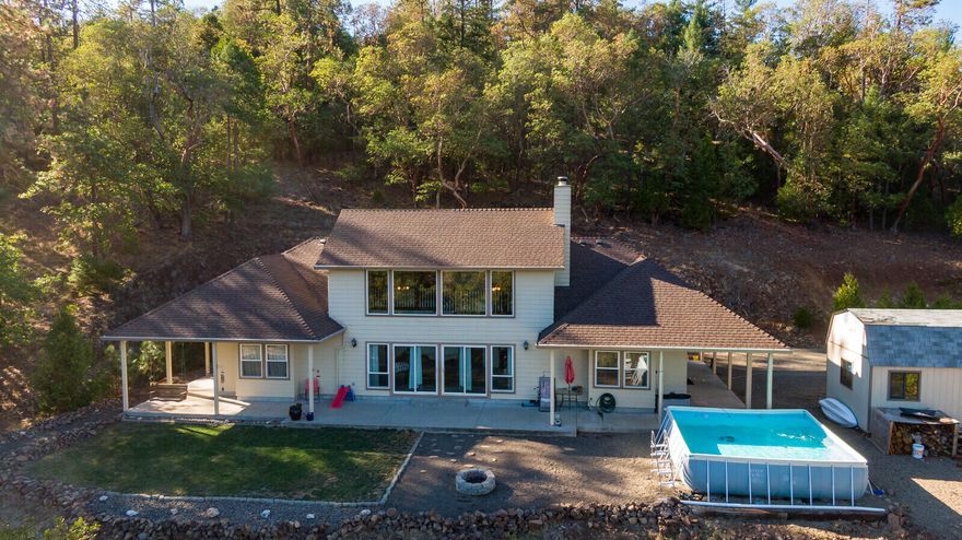 Enjoy panoramic views from this beautiful custom home tucked away in a private wooded setting on over 11 acres! The chef's kitchen offers a 6-burner Five-Star gas range w/2 ovens & griddle, island w/butcher block counter & raised breakfast bar, & separate dining area. Soaring ceiling in the great room w/wood burning stove & incredible views from 2 sets of sliding doors & perfectly placed windows. The gorgeous primary suite has a window seat w/storage, access to the patio, oversized walk-in closet & jetted corner tub. The layout is ideal w/all 3 bdrms in separate areas & a loft/flex-space upstairs. RV parking plus 2 storage sheds, & room for gardening or farm animals.