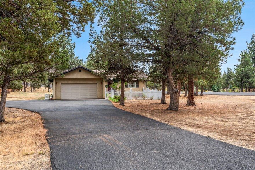 With room for your RV, boat, and all your Central Oregon gear, this corner-lot home offers both comfort and adventure-ready space. Located in the quiet community of Wychus Canyon Estates, this single-level 3-bedroom, 2-bathroom home sits on just under an acre and features low-maintenance stucco siding, a tile roof, an enclosed front courtyard, and an enclosed rear courtyard/patio for private outdoor living. Inside, enjoy vaulted ceilings, new skylights, new carpet, and newer appliances in a light-filled layout. A newer whole-house generator adds peace of mind. Recent updates include tree removal and a new asphalt driveway. The partially fenced yard and outdoor storage add function and convenience. This well-cared-for home is solid, spacious and ready for you to enjoy the Central Oregon lifestyle.