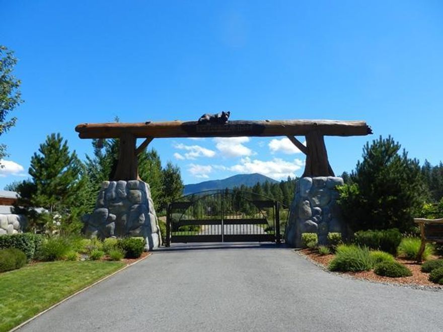 This is a beautiful, private, treed lot, located in the prestigious gated subdivision of Ponderosa Ridge. You will enter Ponderosa Ridge through a stone and log entrance, carved with bears. As you drive along the paved road to this lot, you pass beautifully landscaped areas with lots of grass, trees and a pond. What a great place to build your dream home! Part of the driveway for this lot is paved and is shared with the neighbor. There is a dirt road on part of the property too. There are CC&R's and association fees. Building may be subject to an architectural review board. This is a very special and beautiful place.