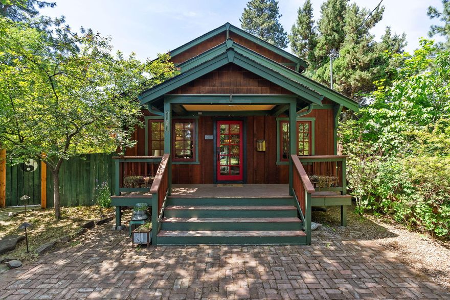 You've discovered it—an iconic, modernized craftsman in one of Bend's most treasured locations. Nestled on a dreamy corner lot, it offers historic charm, natural beauty, and rare privacy. This inviting home is rich in character with newer wood-frame windows, hardwood floors, built-ins, and brick accents. The updated kitchen features cherry cabinetry, subway tile, and a generous island for gathering. A spacious dining area opens to a peaceful brick patio surrounded by lush gardens, industrial heaters, a rock fountain, and a striking ghost tree. Upgrades include modern plumbing, electrical, water heater, furnace, A/C, and added insulation. The vaulted upstairs family room glows with natural light, reclaimed barn wood floors, and a luxurious primary suite with soaking tub and walk-in closet. With curb appeal for days and comfort throughout, this timeless westside gem offers the best of Bend living—past and present.