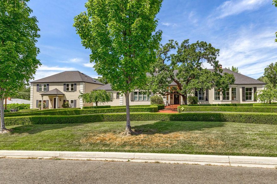 One of a kind French Provincial Estate in the heart of Old East Medford on a rare .83 acre meticulously landscaped lot with inground pool, expansive patios, hedges, walkways, and more. The grand coffered foyer leads to a grand living/dining room with large marble-hearthed wood-burning fireplace, original crown moldings, 8 foot windows, built-in china cabinet and 2 sets of French doors to the entertainment patio. The granite island chef's kitchen offers a newer Sub-Zero refrigerator and ice-maker, 6-burner Viking range and double wall ovens, bonus sitting room with built-in granite desk, plus a convenient pass-through to the morning room. Roomy master suite has new custom-built walk-in closet, all bedrooms are suites, and there are miles of hardwood flooring. A detached second story guest apartment (nearly 900 sqft) with soaring ceilings, granite kitchen and eating bar, Sub-Zero and Viking appliances sits over an extra-large double-car garage. An elegant and truly remarkable property.