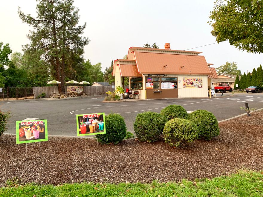 High visibility drive-through business location. Large .28 acre corner lot zoned C-S/P, Service Commercial – Professional Office that is located on the SW corner of the West Main and Columbus Ave. intersection. Currently tenant occupied with the potential for owner occupant. The 328' sq.ft. structure was built in 2004 and has been used as a drive-through coffee shop, BBQ restaurant, and is currently a drive-through coffee & fruit shop. The property is paved and landscaped with access from both Columbus and West Main. The lot is nicely landscaped with an auto-sprinkler system and outside seating area. The 2016 City of Medford Traffic Study estimated that this arterial street location has exposure to approx. 24,000 cars per day. This is a unique opportunity at a time when fast & easy access to products & services is on the rise. All information deemed accurate but not warranted. Use and conditions should be validated by interested parties.