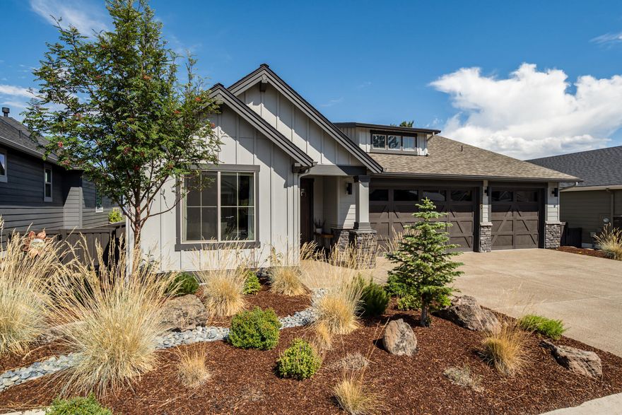 Live the Bend dream surrounded by natural beauty, outdoor adventure, and inspiring views that stretch to Smith Rock, Pilot Butte, and beyond. This is the Chase floor plan by award-winning builder Pahlisch Homes, nestled in the scenic River's Edge Village community. This move-in ready, single-level home offers a front-row seat to colorful sunrises and 4th of July fireworks from your own backyard. Inside, enjoy nine-foot ceilings, Santa Fe wall texture, custom built-in cabinetry, and smart home integrations. The bright, open layout features a chef's kitchen with oversized pantry, spacious dining, and a great room designed for comfort and connection. The primary suite is a peaceful retreat with a soaking tub, tile walk-in shower, and direct access to the laundry room. With three garage bays and quick access to golf, trails, parks, and the river, this home is the perfect basecamp for your Bend lifestyle.