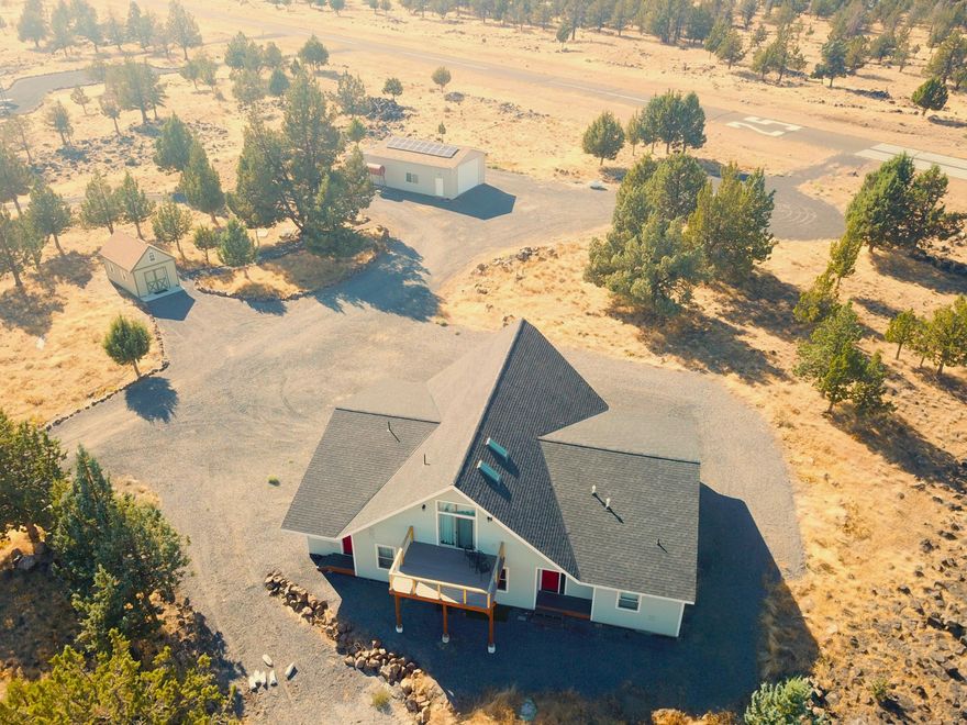 Amazing 6.8 acre property, move-in ready custom built home for full-time or vaca w/370' airstrip frontage to access 3R 2500' paved Airstrip OG00. This traditional home has every amenity imaginable so read the Amenities Sheet for full list. Total of 3290 sf w/3BR, 2.5 Bath, open concept/greatroom, chef's kitchen, Bosch, matt-black SS appliances, huge island, separate wet bar w/frig & storage, large dining area w/pellet stove, over-sized sectional w/large screen TV (Furniture & additional personal items negotiable outside of escrow). Large Primary suite w/2-walk-in closets, double sinks, custom walk-in tile shower & separate enclosed toilet area. 2 spare bedrooms w/large hall bath, tub/shower combo, double sinks & enclosed toilet, also separate half bath, loft which could also be 4th BR, ''sunroom'' and so much more.  The 23w X 52l shop & mechanical building has a 16w X 11h roll up door and houses the solar system & 2500 gallon cistern +++. Truly a must see!