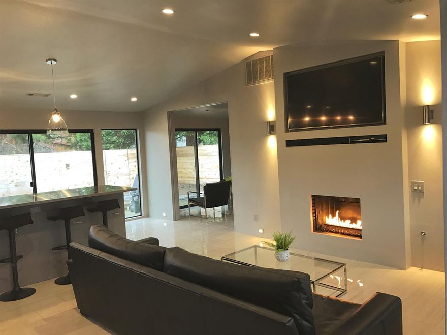 Pinterest comes to Jacksonville! Totally remodeled in 2015 stripped down to the exterior walls. Stunning single level contemporary home, with 3 bdrms, 2 baths, open floor plan situated on .24 of an acre. 2 bedrooms have en-suites. Elegant tile floors throughout. Vaulted ceilings. Living room w/ niches for TV and for the components, gas fireplace with decorative fire glass and there is accent lighting with dimmer switches throughout the home. Kitchen with stainless-steel appliances and countertops, custom cabinets with LED lighting at toe kick, pantry with electrical outlets for the smaller appliances. Large master bedroom with his, hers, and a shoe closet. Beautiful bathroom with soaking tub and large shower. Back yard has an large gas fire pit, modern fence with outdoor lighting, and on the other side of the fence would be a great place for pool, outbuilding, or a garden. Garage is 20x17 ~ approx 340 sqft. Easy landscaping with accent lights. About 4 blocks to downtown Jacksonville
