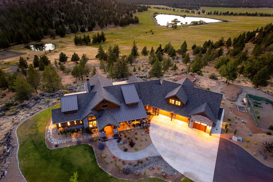 Heart Lake Ranch is a craftsman-styled home 0.7 miles off the public road down a paved driveway. This home sits on a bluff overlooking the property's private valley,  irrigated fields and is high enough to take in views of 7 Cascade Mts. The 3-bed suite, 3.5 bath layout showcases the finest craftsmanship and materials, from reclaimed wood accents, over-size timbers, top-of-the-line appliances, granite counters, solid wood custom cabinets and trim, and much more; this home is luxurious. If that is not enough, across the yard is a 3,336± square foot finished shop that is more of a family room than a workshop—with polyurea-coated floors, finished walls, a custom cabinet, an 8000-pound car lift, wet bar, and a 16' HD Golf simulator/theater. There is a second shop for storage. Below the home are 63± acres of irrigated fields with pop-up sprinklers surrounding Heart Lake, a 7.5-acre private lake stocked with trout, bass, and bluegill. There is a ''boat house'' for storage with a covered pat