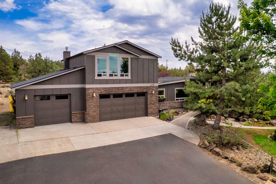 Enjoy breathtaking Cascade Mountain views from this beautifully updated home on nearly an acre in SW Redmond. Ideally located with easy access to Bend, Redmond, Ridgeview High & Sage Elementary. The expansive lot features a huge backyard with access from 45th St.—perfect for an ADU, 2nd residence, or shop (buyer to verify). Inside, discover vaulted ceilings, hardwood floors, granite counters, stainless appliances, and a stylish double-sided fireplace beneath warm wood-accented ceilings. Upstairs, a luxurious primary suite offers a walk-in closet, tiled dual-head shower, and soaking tub with panoramic views. With two primary suites and an oversized lot, this home is ideal for multi-gen living, guests, or flexible use. Additional features include a 3-car garage, chicken coop, greenhouse, planter box garden, and a newer hot tub—plus space for RVs, toys, and future plans. A rare blend of space, privacy, and convenience—don't miss this high-desert gem!