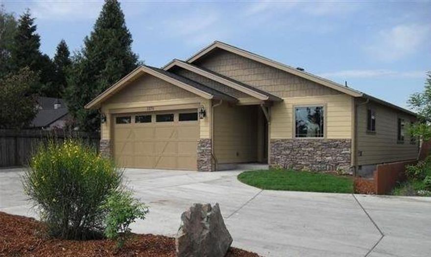 This craftsman style home has custom features at every turn from the cathedral height ceilings, to the granite countertops, metal and stone mosaic backsplash tile, stainless steel appliances dual wood cabinetry, tile floors, double shower head shower, RV parking, large fenced yard, extra-large extended patio and so much more. The home's warm color scheme and craftsman style moldings make this such a modern yet cozy home. This home is located near the newer South Medford High School and so many other conveniences!