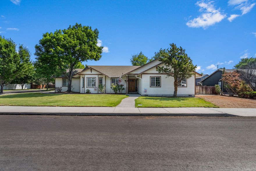 Located in a highly sought after NW Redmond neighborhood, just blocks from Quince Park & the Dry Canyon trails! This charming single story home w/ 3 bed, 2 bath & 1460 sq ft of open living space. Inside, enjoy vaulted ceilings, laminate flooring throughout (NO carpet!), a cozy gas fireplace & a spacious kitchen w/ a pantry, newer stainless steel appliances, a breakfast bar & breakfast nook. The oversized primary suite features a walk-in closet, double vanity & shower stall. The laundry/mudroom w/ a sink adds function & convenience. Water heater was just replaced. Outside, you'll find RV parking, a 3 car garage, privacy fencing, a storage shed & large deck perfect for entertaining. All on a fully fenced corner lot. Call your agent today to schedule a showing!