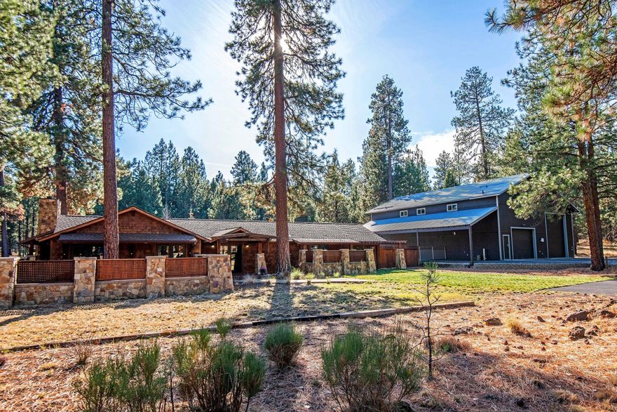 Dream property, dream home! Single level 2,828 square foot mountain cottage totally and beautifully remodeled and featuring extensive use of wood and stone. Fenced two acre parcel with space for horses, gardens, tennis or pickleball courts. Access to National Forest trails just 100 yards away. Huge 2400sf heated shop with bonus room up. Great barn for horses or essential toys. Perfect home for aging in place with high end finishes, radiant in floor heat, open floor plan and 36' wide doorways. Expansive stone courtyards and patios. Multiple full hookups for RVs. In a development surrounded by National Forest. This property meets the 2 acre minimum to be eligible for an Accessory Dwelling Unit (ADU)! Please see www.deschutes.org/adu for more information.