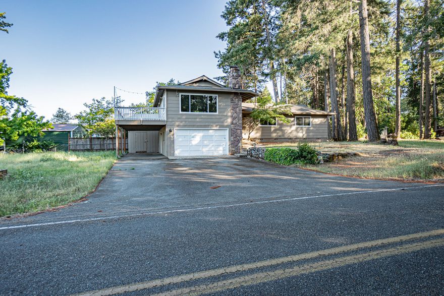 PRICE IMPROVEMENT OF OVER $45,000! 
 Beautifully renovated home featuring 1533 sq ft (per FHA appraiser)* with 3+ bedrooms and 2+ bathrooms on a spacious .7 acre corner lot. Nestled on the outskirts of Grants Pass, it offers a serene rural ambiance while still being conveniently close to town amenities. The home showcases an inviting open layout integrating the living room and kitchen, complete with a cozy fireplace, built-in media stand, granite kitchen island, stainless steel appliances, pantry, and dining area with a built-in bench. Updates extend to the bedrooms, bathrooms, and a well-appointed laundry room with additional built-ins. An attached garage includes a finished basement area featuring a bonus room and a third bathroom.(*Per Assessor 1520 sq ft above grade and 280 sq ft below grade 4 bed - 3 bath.)