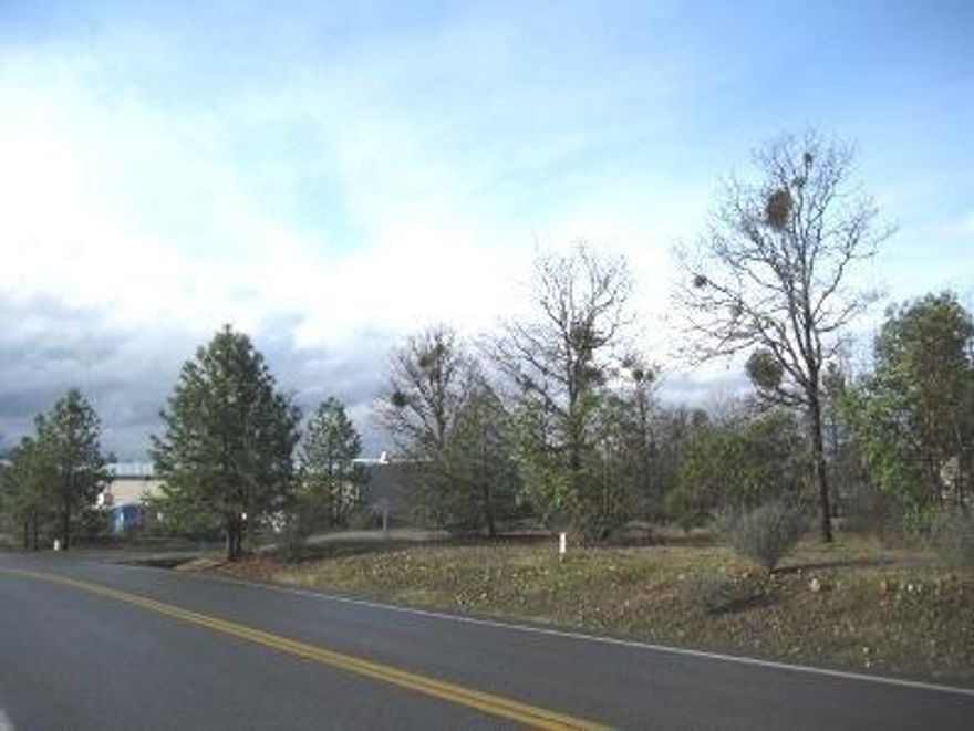 This flat, 1.4 acre lot is located in rural industrial park near the I-5 corridor, just North of GP. Zoned light industrial. Natural gas, city sewer and city water available. Close to small airport, 35 miles from Medford Intl. airport and close to rail road. This land is in front of 276 Tech Way. Phase 1 Environmental Assessment was done in 2010 and is available to be viewed in listing agents office. Survey maps also available as well as much more information.