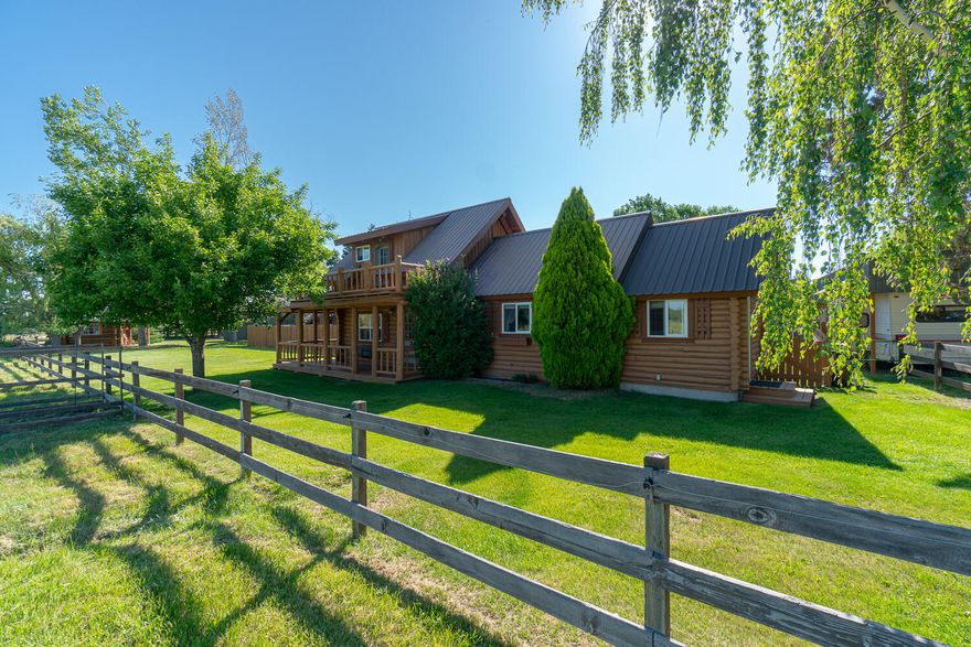 Full of NW Charm w/ stunning Cascade Mtn views, this log cabin is located on 5.03 acres (4.5 irrigated) w/ a unique property layout that feels like your own private paradise. Log cabin ftrs wrap around covered porch. Main entry leads to living area w/ wood burning stove. Kitchen ftrs double sink w/ window looking out into the pasture & towards the mountains. Downstairs also ftrs a small bedroom/bonus room, mudroom/office space, storage nooks & full bath w/ step in shower. Upstairs ftrs primary bedroom w/ vaulted ceiling & private balcony to enjoy the views. Fenced & landscaped backyard area w/ back porch is well maintained w/ small garden shed. Dotting the property you'll find other unique sheds plus a 5th wheel w/ deck that comes w/ property. Min from Redmond, Hwy 97 access, & the Deschutes River, this location is perfect for easy access while also offering ultimate privacy. Gravel drive leads to the detached 2 car garage & covered carport area w/ plenty of space for boat/toys/shop.