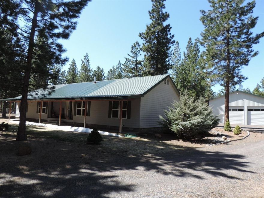 Quiet & peaceful setting that backs to Public Forest Lands on the west side of Ponderosa Pines, entirely fenced w/cyclone fencing & electronic gates. Detached shop is 60X40 w/interior insulated & heated man cave, Two 13 1/2' doors for storing the RV. Exterior Hot Tub to watch the stars & listen to the pine trees. Detached 2 car garage w/wood-shed. Home has tons of upgrades, open floor plan w/master separation, vaulted ceilings, heat pump, wood stove, & den w/cute barn door! Won't last at this price!