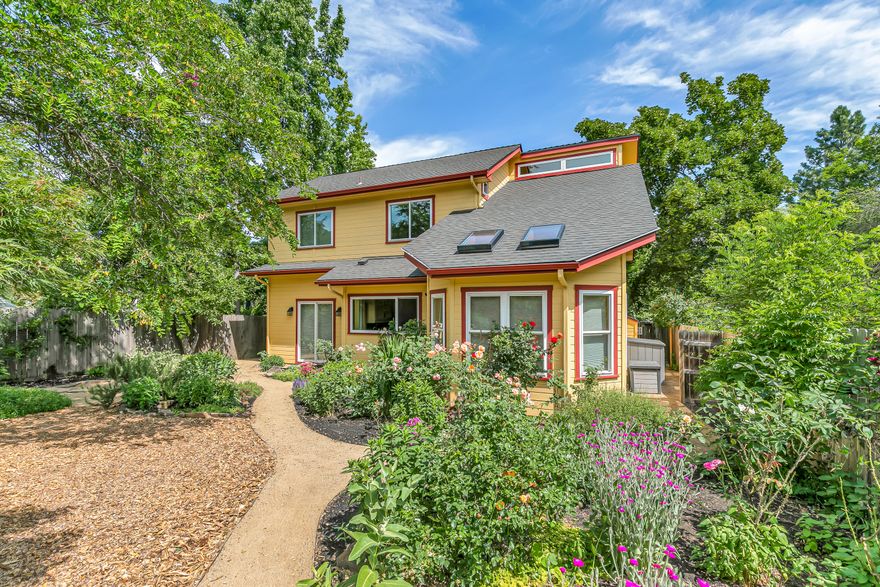 Thoroughly updated view home with private park-like organic gardens near The Siskiyou School and YMCA! Great room with soaring vaulted ceiling, abundant natural light, solid oak floor, river rock gas fireplace, powder room, formal dining with interior French doors to sunroom with skylights and tiled floor, kitchen with new tile backsplash, counters, and island with mosaic tile and metal edging, Blanco quartz sink with water purification unit, refinished cabinets with new hardware, and updated appliances including stainless steel Samsung five-burner range with convection oven and hood. Main level primary suite with sliding glass door to backyard, walk-in closet, completely renovated full ensuite bath with new porcelain tile floor and shower surround, double quartz vanity and mirrored medicine cabinets, water closet, and cedar-lined sauna. Upper level with spacious loft, three bedrooms, and updated full bath. Home is set back ~60' from Clay Street. New roof in 2024. Inquire for details!