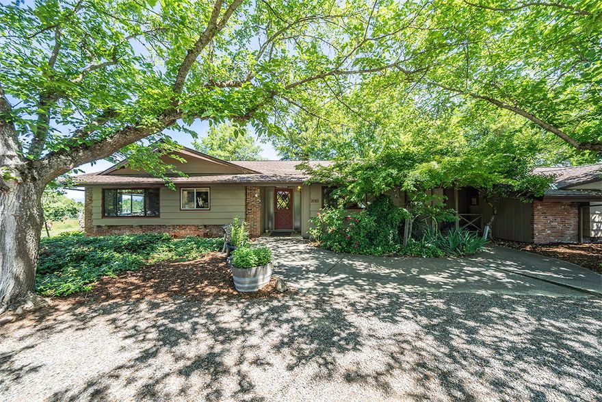 Gardener's dream property! 2312sf single level home with attached mother-in-law apartment offers 4 bedrooms and 3 full baths. Nearly an acre of irrigated property with tons of beautiful flower and vegetable garden beds, small pond, greenhouse, fruit trees and cross fencing. This solid home features soaring vaulted, wood-beam ceilings in the great room, beautiful hardwood floors, slab granite counter tops and a slate entry. Part of the total sq. footage is an attached Mother-in-Law Quarters, with one large room and a full bathroom. Peaceful pastoral views, a detached 4-car garage and a separate workshop, plenty of RV Parking and shed.