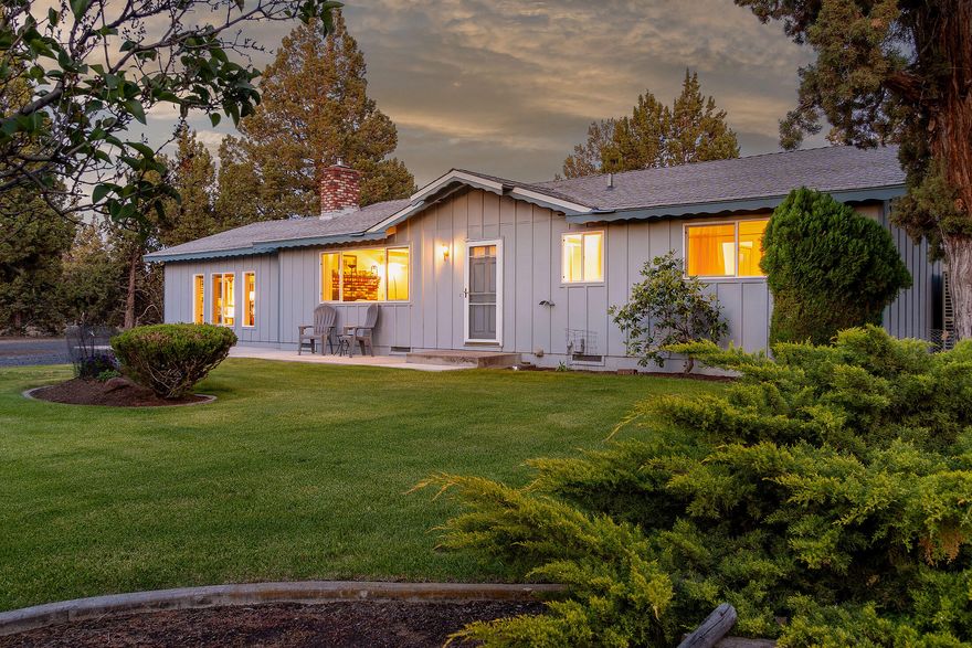 Comfortable living offered in this well-constructed & updated 4 bed, 2 bath, 1,272 sq ft home built in 1973 on 2.5 acres just NW of Bend. Exceptional privacy in this peaceful rural setting situated among mature trees & lush landscaping with underground sprinklers, drip system, & fruit trees. The living room features a wood stove insert with brick hearth, mini-split for efficient heating & year-round comfort. Extended outdoor living on the covered back patio allows you to enjoy the thoughtfully designed landscaping that creates a peaceful retreat. Fenced and gated property with large garden area and natural space for ample parking. Heated garage/shop with built-in workbenches, & additional carport offers room for projects, storage and parking easily accessed by circular drive.