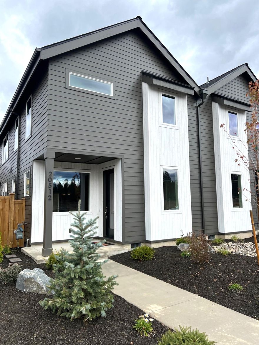 The main level of this beautiful 3 bedroom, 2.5 bath townhome features a bright kitchen, dining area and great room. Upstairs you'll find the primary bedroom suite along with 2 additional bedrooms, full bath and utility area. The kitchen features solid surface counters, tile backsplash, island and stainless steel appliances. Composite wood floors throughout main living area, bathrooms and utility room for a cool modern feel. Bathrooms have solid surface counters and backsplash. Primary has dual vanity, tile shower & walk-in closet. Ductless heating & cooling system for year-round comfort. And a covered patio, full landscape and fenced rear yard for convenient outdoor living space.