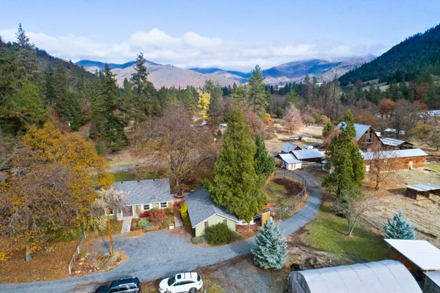 Looking for that perfect property that has it all. Well here it is. This sprawling EFU property has 2 nice single family homes, a large pole barn, several workshops and outbuildings, a milking barn, 3 farm hand
mini homes, several hoop houses, water rights to Thompson Creek that runs through the property, 2 man made reservoirs used to irrigate the upper fields, hiking and riding trails throughout the property that is backed to BLM. The original home is a beautifully updated 2/1 mid century farmhouse with
detached 2 car garage + outside office. This home has been nicely updated with porcelain tile, hardwood floors, spacious kitchen with stainless steel appliances, granite counters and a large breakfast bar. The 2nd home is a newly finished custom 2/2 straw bale home with cherry floors and vaulted ceilings. This home has a very energy efficient soap stone stove and spacious layout. There are just too many
features to list.