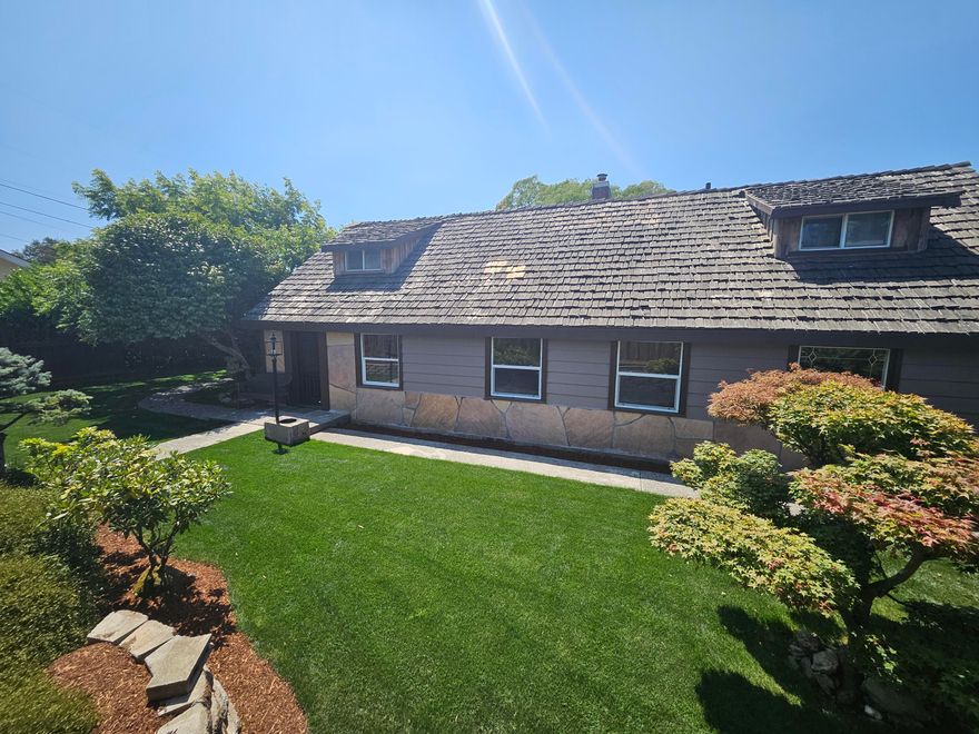 CUSTOM UPDATED FARM HOME THAT HAS AMERICANA ALL OVER IT! HOME SITS ON JUST UNDER A HALF ACRE (AT 0.44 AC) WITH PEAR & APPLE TREES, GRAPES AND MORE! ENJOY THE WATER FEATURE THAT FEELS LIKE YOU ARE SITTING ON A MOUNTIAN CREEK ENJOYING YOUR FAVORITE DRINK! VERY MANICURED YARD WITH MATICULOUS EASY UPKEEP LANDSCAPING! PRIMARY BEDROOM ON MAIN LEVEL GENEROUS LIVING ROOM WITH FIREPLACE THAT HAS A WOOD STOVE INSERT, PLUS THE HUGE FAMILY ROOM (OR A 4TH BEDROOM YOU DECIDE JUST ADD A CLOSIT) WITH SLIDING GLASS DOOR TO THE GARDEN AREA. THE KITCHEN HAS AN ABUNDANCE OF CABINTRY AND COUNTER SPACE WITH AN ISLAND WITH TOO! PLENTY OF SPACE INSIDE & OUTSIDE THE HOME PLUS SHOULD BE EASY TO CREATE A 2ND LOT IF YOU DESIRED OR BUILD A HUGE SHOP WITH MORE PARKING THIS PROPERTY COULD HAVE IT ALL! IT IS A JOY TO SHOW AND EASY TO JUST CALL!