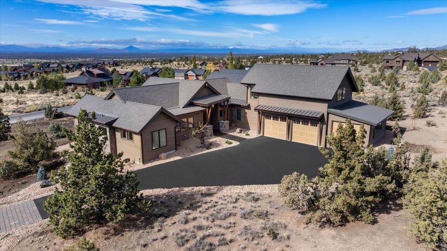 Mountain modern NEW CONSTRUCTION w/ UNRIVALED CASCADE VIEWS. The entire West wall of the Great Room is a stunning expanse of oversized windows and sliding doors, offering panoramic mountain scenery from every major room. The light-filled, open-concept plan features high ceilings, durable engineered wood floors, and a dramatic floor-to-ceiling stone fireplace. The gourmet kitchen boasts a massive island bar, cabinets to the ceiling to optimize storage, and a professional range. The luxurious primary retreat is on the main level and includes direct deck access and spa bathroom. This highly functional plan is completed by two additional bedrooms each with ensuite bath. Upstairs, a large bonus room above the garage features its own ensuite bath and extensive storage—ideal for a media room, guest quarters, or home gym. The expansive West-facing deck invites you to envision limitless outdoor possibilities. Ranch lifestyle offers all the benefits of membership (Pools, Golf Course, etc.)