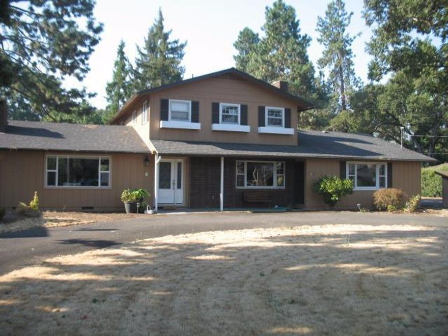 Amazing opportunity to own a large 3 bedroom, 3 bath home with elbow room yet super close to town. Beautiful engineered dark wood flooring on lower level with open kitchen, marble island, wide base boards and private den or formal living room. Upstairs are 3 bedrooms and 2 baths. Shop is HUGE- approx. 1500'. Large 1/2 acre lot with plenty of sun exposure for a pool, garden, etc. This home has some work to bring it back to life and therefore will require a 203K loan or cash. Office off the garage with it's own entrance and closet. (Side job, work from home or extra bedroom.)