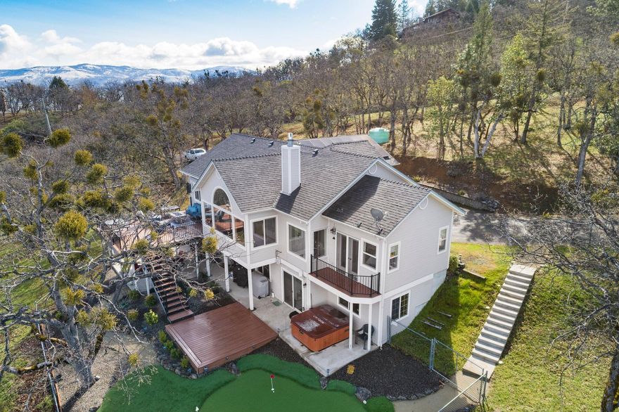 Unique property first time on the market! This is a 4 bedroom 3 bath home with 2228 sq. ft  that sits on 5 acres in a very desirable area of the Rogue Valley. With unparalleled vistas of the valley. Ideally located close to wineries, 10 minutes to Jacksonville, 15 minutes to Ashland, 10 minutes to Medford, and 15 minutes to the Rogue Valley International Airport. With three bedrooms and two bathrooms located on the main floor, the fourth bedroom is downstairs with a private bathroom with a separate entrance. The two bathrooms recently remodeled in 2021 with walk in tile showers, and the primary bathroom has just been completed with walk in tile shower with picture window views of the Rogue Valley, the roof was installed in 2017, the home is energy efficient and features a 4.49kw Solar system that is owned. Outside there is a huge 440 Sq. Ft. deck where you can take in the views and entertain. There is also a lower deck with a spa for more private settin
