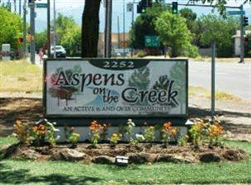Located in the beautiful Aspens on the creek, a 55 an older community, this super cute home is move-in ready! This place has been well upgraded by the seller. In 2009 the seller added a new roof, new Train Clean effects heating/air system, updated windows, double cell blinds, walk in shower, non-skid cushioned vinyl throughout, new counter tops, stove/oven and paint! This home was set up for someone who had allergies so having the special Train system and vinyl is a real plus. It has a huge covered patio, a gorgeous butterfly garden as well as three raised flower beds. The grounds were just graveled and it has a covered carport with a shed for storage! It's a great value and ready for new owners!