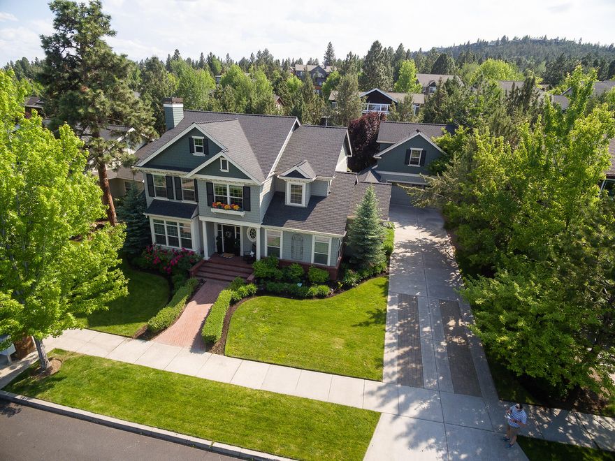 Introducing an exquisite masterpiece with incredible curb appeal, this stunning Awbrey Park property boasts a 3428 SF main home, detached 672 SF studio & storage shed behind the garage. Impeccable craftsmanship enhances the overall ambiance, with coffered ceilings, wainscoting, light-filtering glass, and beautiful fireplaces. The gourmet kitchen serves as the central gathering space with casual seating around the island. Unwind in the Japanese-style jetted tub in the main floor primary suite after a busy day. 3 bedrooms upstairs, along with a bonus loft perfect for play, study, or movie nights, offer children or guests their own private oasis. The formal dining room overlooks the fenced back yard adorned with a spacious patio & a pergola with retractable shades. Located across from Sawyer Park with a field, playground & trailhead to the Deschutes River trail, you can enjoy unobstructed views of the Ochoco Mountains and nature.