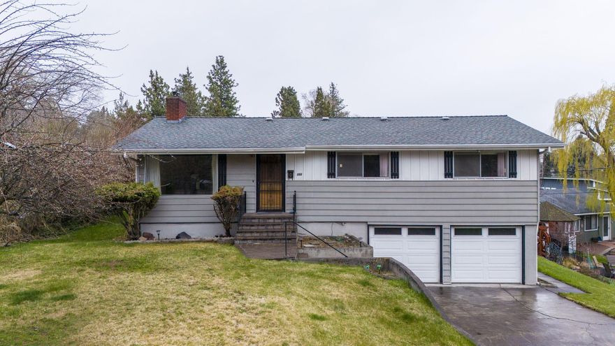 Classic mid-century home located in NE Bend's Orchard District on 0.24 acres w/development opportunities for the savvy buyer. This prime location is min from Hwy 97 access, Pilot Butte, Orchard Park, & all Downtown Bend has to offer!  4 beds, 2 baths & 1536 sf of living space w/rear alley access. Main living area is open & bright w/a cozy stone fireplace, carpet that has hardwood underneath plus there is an additional family room downstairs! Kitchen ftrs plenty of storage & counter space for prep, vintage appliances & open dining area w/sliding glass doors. 3 bedrooms on main level  w/full bath & another bedroom downstairs w/full bath. Potential income opportunity when considering turning downstairs family room, bed/bath into a separate dwelling space. Huge yard w/plenty of room for outdoor activities & entertaining. Covered Deck off the dining area, double car garage, & RV spot out back. Potential to add additional accessory dwellings or lot subdivisions. Bring your imagination!