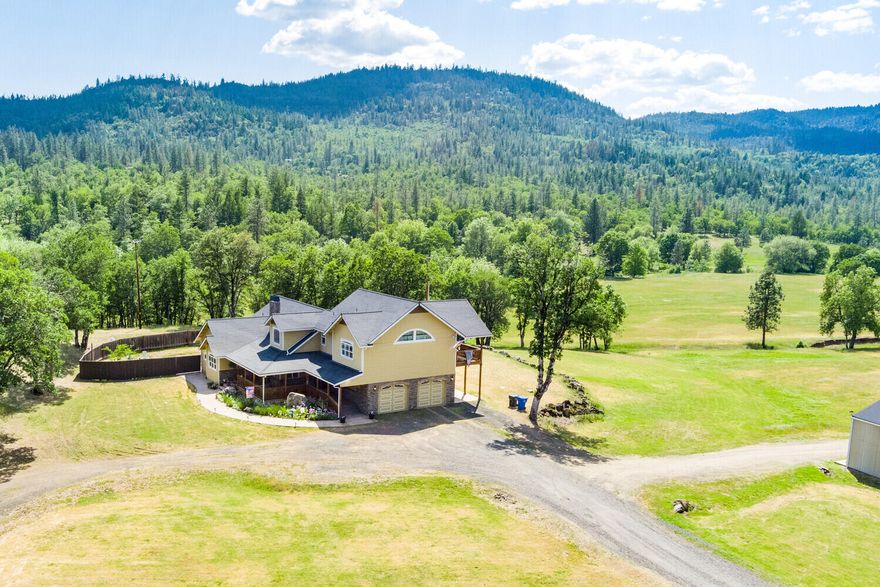 Introducing Long Branch Ranch! Just on the outskirts of Shady Cove, OR sits this well cared for and loved ranch. The very comfortable and well appointed home features 4 bedrooms, 3 bathrooms with 2 separate master suites, hardwood flooring, a grand fireplace and fabulous outdoor spaces! This would make an excellent 2 family setup or have plenty of room with a private upstairs suite for out of town guests. The picturesque setting has acres of horse or cattle pastures, has 2 seasonal creeks running through it, has several acres of timber, is bordered by BLM land, and has a plethora of wildlife including a resident elk herd. The property also features a 3,000+ square foot shop, an equipment pole barn,  and unsurpassed views in all directions. This is your chance!