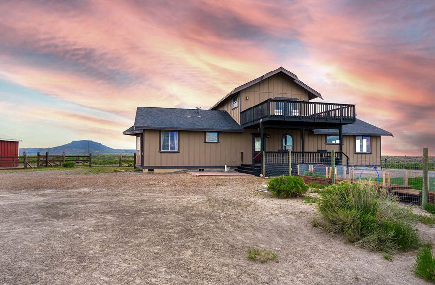 Escape to this sanctuary nestled on a low-maintenance 39+ acres, complete with a barn and small shop. This delightful property features a layout with all living spaces on the main floor and a bonus room upstairs. Home has elegant slate and Acacia wood flooring, tasteful tile accents, and a Great Room design. Luxuriate in the master suite with amazing views, a clawfoot tub, a custom two-person tile shower with rainfall showerheads. Bonus room has amazing views and a wet bar/kitchenette. Step outside onto the raised deck, and admire the fenced surroundings with ample space for privacy and relaxation. Enjoy the picturesque views of Table Rock, Sleeping Maiden, and beyond, as well as the mesmerizing sunrises, sunsets, and endless skies ablaze with stars. A stargazer's paradise. This idyllic retreat promises tranquility and solace, making it the perfect place to call home