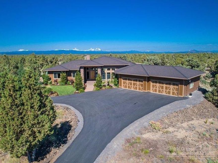 Beautiful custom built one level home in Powell Butte. Builder's own home was built to take in the Mt Bachelor to Mt Jefferson views. Impressive floor to ceiling fireplace in the Great Room. Formal dining with custom drop ceiling & custom accent lighting. Gourmet Kitchen. 14ft ceilings in Great room 10ft ceilings in the rest of home. 2 master suites. Office & Media room, 4 car garage (divided for work shop area). 36x60 Shop, 36x36 Barn. Bordered by BLM on 2 sides.