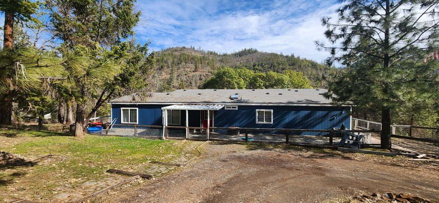 Spacious Triple-Wide with Stunning Views of the Rogue River!

Looking for extra room to spread out? This expansive 2,352 sq ft triple-wide manufactured home offers everything you need and more. Featuring 3 bedrooms, 2 bathrooms, and 2 separate living areas, there's plenty of space for family, guests, or entertaining. A wood-burning stove adds a cozy touch for those chilly winter nights.

The roof was replaced approximately 5 years ago (per seller), providing peace of mind for years to come. Step outside onto the massive wrap-around deck—partially covered—for panoramic views of the surrounding mountains and the picturesque Rogue River.

Situated on a generous 1.25-acre lot, the property also includes:

A detached double-car garage with a finished bonus room.

RV parking with power and sewer hookups.

Ample outdoor space for gardening, recreation, or additional storage.

This property blends comfort, function, and scenic beauty all in one. Buyer to verify all information.