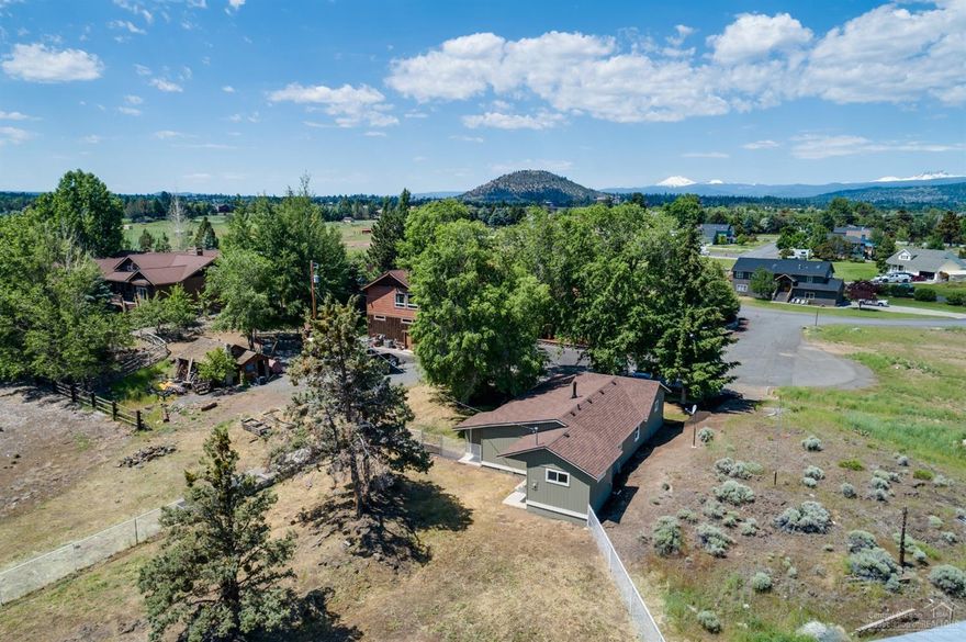 Talk about a C-U-T-E Remodel! Floor to ceiling, front to back remodel of this 1936 Vintage home. Just about NEW everything...New wood stove with original rock wall. New white washed wainscoting, flooring,, lighting, paint, windows, fixtures, layout of the living, dining & kitchen areas, cabinetry w/laminate counter tops, eat at bar. Huge laundry room w/space for crafts, exercise equipment etc. Bar doors glide to reveal your new pantry. Brand new bathroom, cabinetry w/single sink, toilet, tub-shower & flooring. Zonal heating in bedrooms & bath. Now let's go outside, fenced back yard backs to the seasonal canal. Situated on .64 acre lot in Bradetich Park. Just off the paved court is gravel parking area with enough room for the RV too! Bring your imagination for the rest of the grounds. Just minutes to local events and year round recreation in Central Oregon.