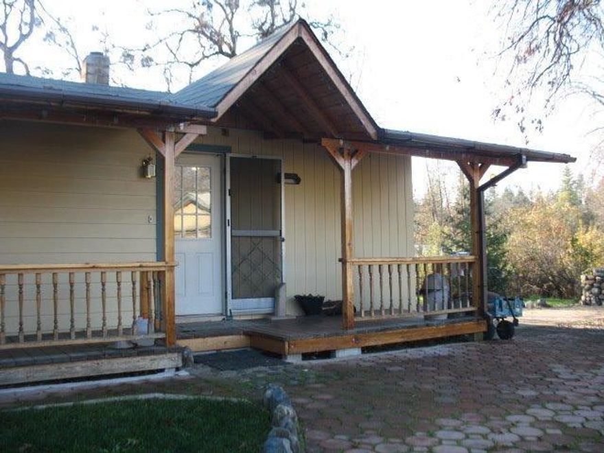 Charming 1956 built 2 bedroom, 2 bath home on 3.48 private and wooded acres. Jump off Joe Creek runs behind the property. Newer laminate flooring throughout home. Lovely sunroom/mudroom adjacent to spare bath/ laundry room for either quiet reading time or practical clean up from outdoors. Relaxing hot tub inside surrounding gazebo with great views of nature. Master has newly installed shower inset with hot tub, Jacuzzi, steam and shower all in one. Vaulted beam ceilings in master and private deck to watch sunsets. Gas fireplace in living room with bay window. Amazing garden area all fenced off from wildlife- just needs to be brought back to life. Grapes, fruit trees including- apple, quince, pear, plum and cherry. Electric gate at entry of property. Sensor lights around property. 2 full and one partial RV hook-up. Detached 2 car garage and several outbuildings for animals along with a 22 x 24 shop.