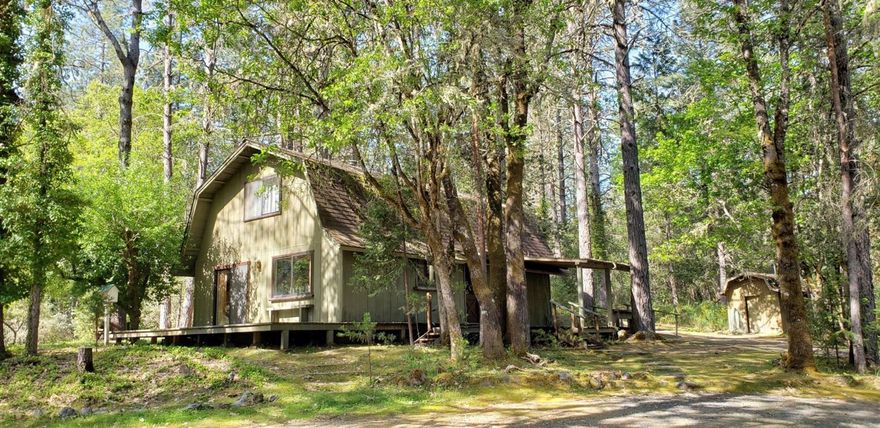 Beautiful treed 5 acre parcel with Ewe Creek running through it. 2 bedroom, 2 bath, 1728 sq. ft. Gambrel style home. 1 bedroom downstairs, the second bedroom is upstairs, there is also a large room that could be 2 more bedrooms, or a huge master suite. Kitchen is open to dining area, with living room just off that. Home is clean and livable, but ready for an update. Well log shows 30 GPM. This is a cute home, in a lovely setting! Shop/barn is in poor condition, but could be rebuilt. All info deemed reliable, but is subject to change and should be verified by Buyer.