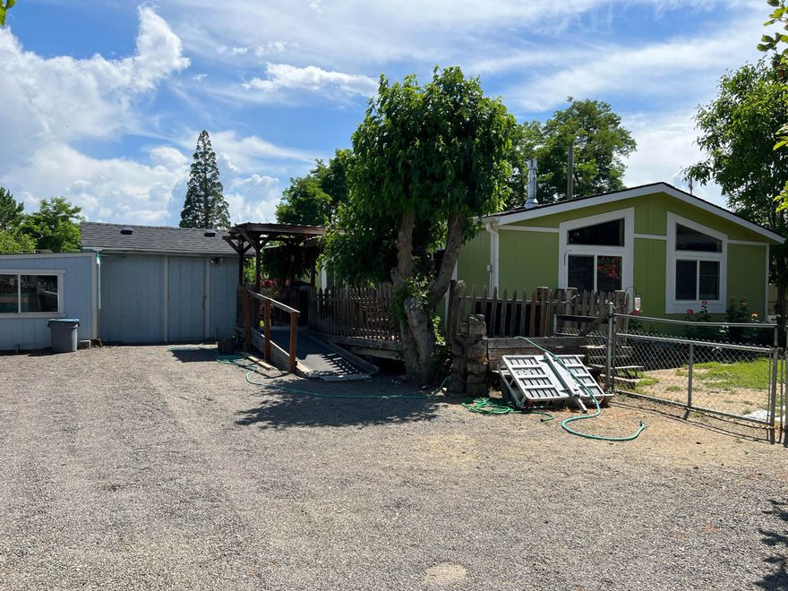 Water Water Water!  Well produced 60 Gal per Minute when drilled in 1990. UV Filter System and Salt Softener system installed in 2020.  New Roofs on all outbuildings. Easy Maintenance Mature trees, Roses, and landscaping.  Huge Garage/Shop with gas heater, electric winch lifts and lots of shelving.  Small green House, Poultry Coop, and Storage sheds.  Fully Fenced property with amazing views of Table Rocks and mountains. Lots of room and parking for all your toys and equipment. Natural Gas Plumbed to House and Shop. Has a current Medical Hardship permit.  Single Wide Manufactured Home on property is also for sale and will be removed.