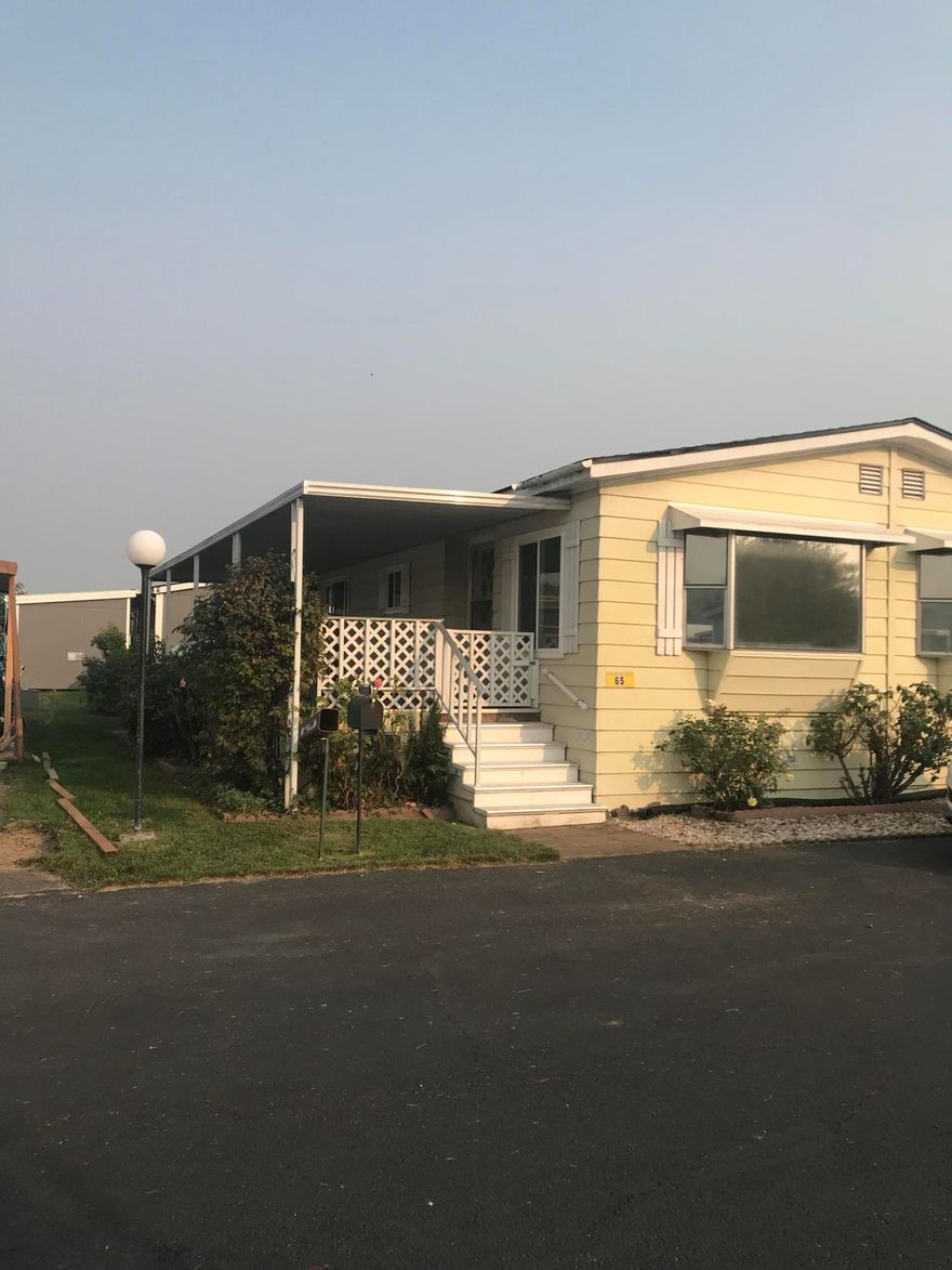 Spacious 3 bedroom, 2 bath home located in the beautiful 55+ Riviera Mobile Park near the Rogue River.  The home features a living room, family room (which can be used as a large dining area), and indoor laundry with storage.  One bedroom features a Jack n' Jill access to the laundry room - for easy access when coming in from working in the yard. Home includes all the appliances, new roof in 2020, Heat & A/C, and nice size shed / workshop.  Vinyl windows, and Carport large enough for two cars.  Enjoy the spacious front porch while sipping your coffee or tea. This home has easy access to the Rogue River for fishing, birdwatching, or just relaxing.  Also available to residents is an active community and club house (after Covid). 
 Park approval required.  One pet allowed. Check with Park Management.  RV storage available - check with Park Management for additional cost.