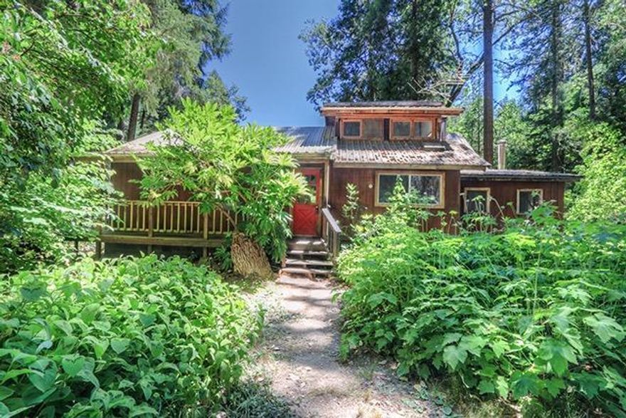 Custom Timber-Frame Cabin on 6.64 Acres of Seclusion in Williams. Home was Owner-Built and is Wood-Finished inside and out, offering that Attractive Look that makes the Home perfectly fit the Property. Open Living Design between the Country Kitchen, Living, and Dining Areas. Main-Level Master Bedroom and Bath, Sunroom, and an Office/Den Room that could easily be another Bedroom. Upstairs is another Attic-Style Bedroom. Certified Woodstove for Heating, and Metal Roof on the Home. Large Wrap-Around Wood Deck offers nice Outdoor Living Space. There is a smaller Older Shop Building that is in fine condition, and attached to that is a cool detached Bedroom/Guest Space. In addition, there is also an almost-new very nice Shop Building with Vaulted Ceilings, Skylights, and Power. Other Outbuildings include a nice Greenhouse/Garden Shed, several Storage Sheds, and a Fully Functional Outhouse. A Fenced Garden Area and numerous Fruit Trees are ready for your enjoyment, as well an Outdoor Shower!