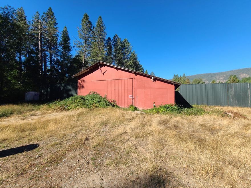 Beautiful Mostly Flat 5 Acre Property With Additional 1.53 Acre Separate Tax Lot & Seasonal Stream! There Is Large Shop Built With Round Wood Timber & Electrical For RV Hook Up! Home Is Uninhabitable & The Value Is In The Land & Oversized Shop!! Owner May Carry With 100K Down Short Term. Well & Power To The Property. Previous Well Flow Report On File From 2024 Averaging Approximately 5 Gallons Per Minute. All Information Is Deemed Reliable, But Not Guaranteed! Buyer's due Diligence!