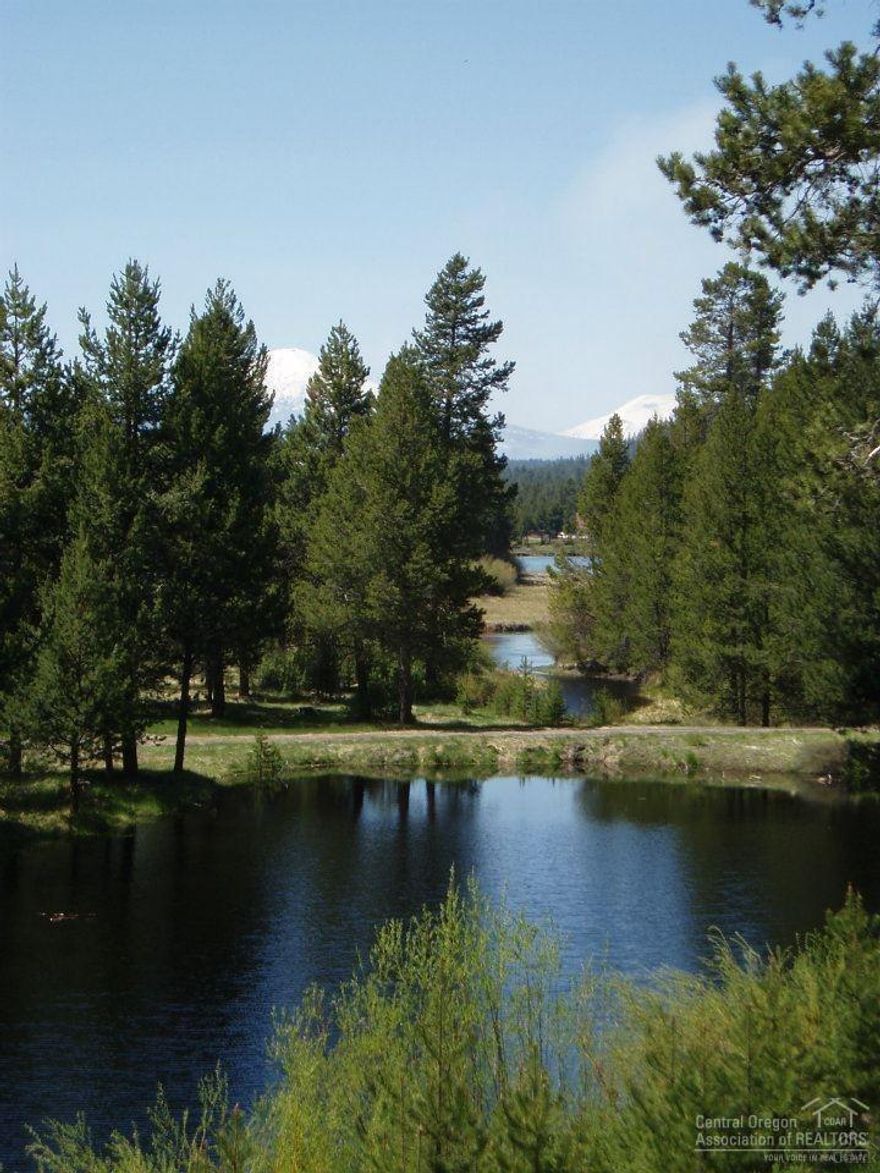 Extremely rare 70+ acres of seclusion on the Big Deschutes River w/ private harbor access to river. Lodge style w/expansive 40x40 great room overlooking river, harbor, private 3 acre lake, Cascade Mt. views. Just 20 min. to Bend. A +/-3000 sq. ft. remodel in the 90's. Main level living w/2 master suites. bonus rooms in daylight basement, gourmet kitchen, 3 car garage w/room above. Park like setting. Tax deferral on 65 acres at just $60 per yr. 2-M49 res. lots app. on property. Deer,elk,ospreys & privacy.