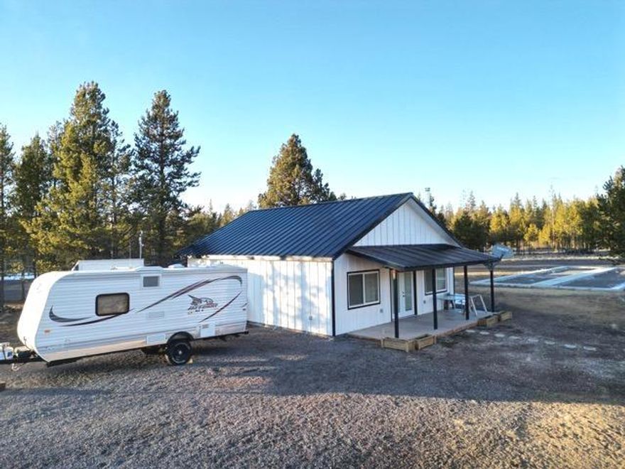 Scenic 9.33-acre property near La Pine, bordered on 2 sides by BLM land. Walk or ride your toys out the back of the property for some recreation fun. Features include a versatile workshop, storage, barn, well house, 2 storage containers,  RV hookups, well, and septic providing for a tranquil country living experience. There is a prepared pad for a manufactured home placement. Surrounded by nature, enjoy abundant wildlife, breathtaking sunrise/sunsets, and the serenity of the peaceful countryside. Ideal for those seeking a harmonious blend of outdoor living and practical amenities. Currently used for recreation.  Must see to appreciate this one of a kind property. Sellers are motivated.  Buyer to do their due diligence.